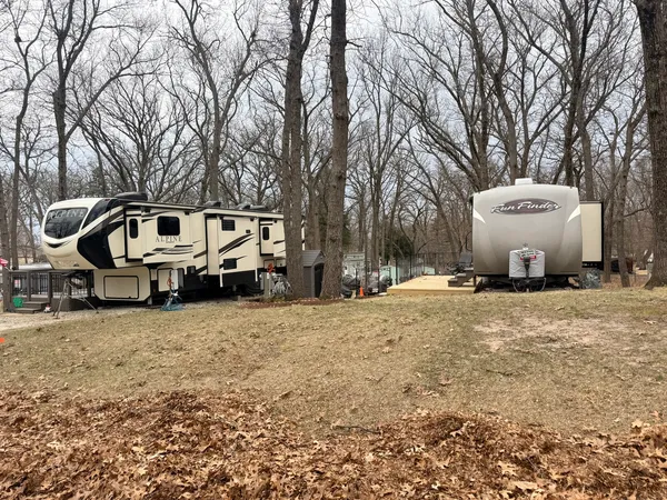 a front view of a house with a yard covered in snow