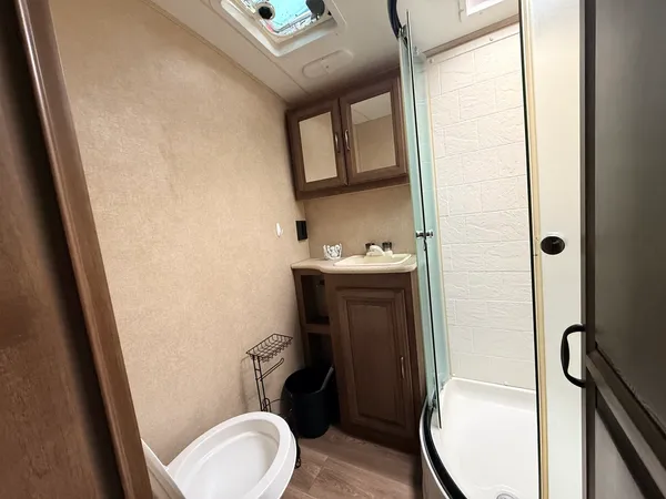 a bathroom with a toilet a sink and mirror