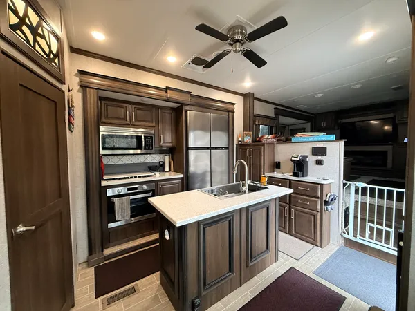 a open kitchen with a stove and a refrigerator