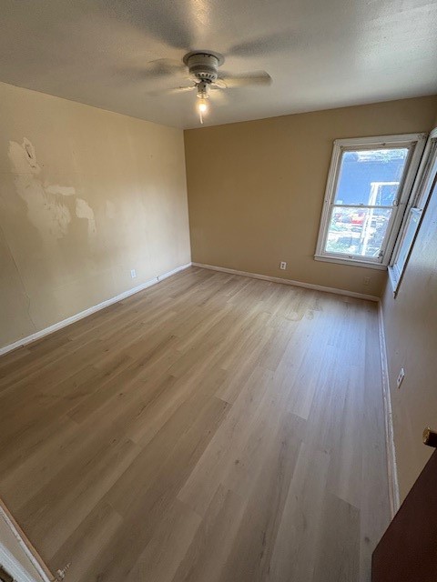 503 Marie Place Beeville, TX 78102 - Photo 13 of 30 an empty room with wooden floor fan and windows