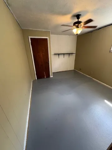 a view of an empty room with a fan