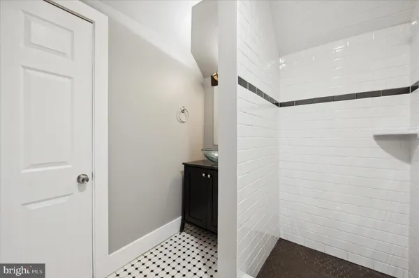 a bathroom with a shower and a sink