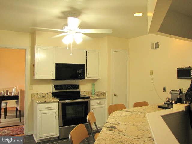 10277 Gainsborough Road Potomac, MD 20854 - Photo 8 of 14 a kitchen with a stove a sink and a refrigerator