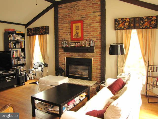 10277 Gainsborough Road Potomac, MD 20854 - Photo 9 of 14 a living room with furniture a window and a fireplace