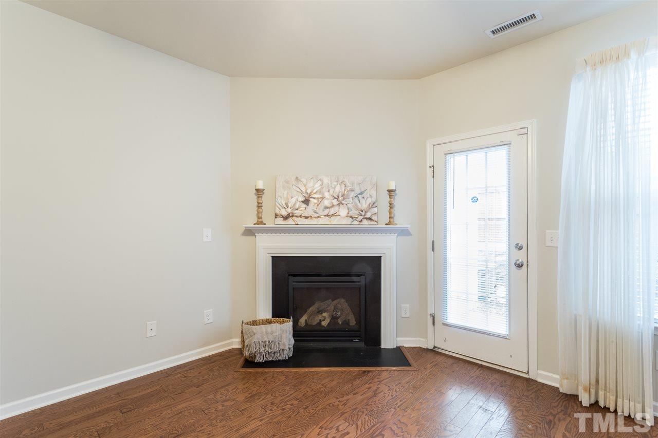3106 Berkeley Springs Place Raleigh, NC 27616 - Photo 12 of 26 a living room with furniture and a fireplace