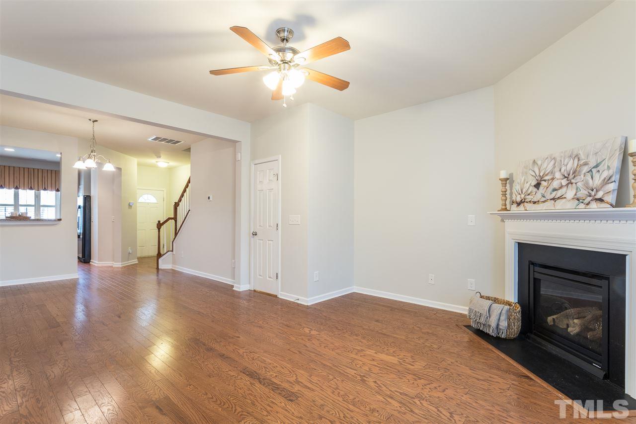3106 Berkeley Springs Place Raleigh, NC 27616 - Photo 13 of 26 a view of an empty room with wooden floor and a fireplace