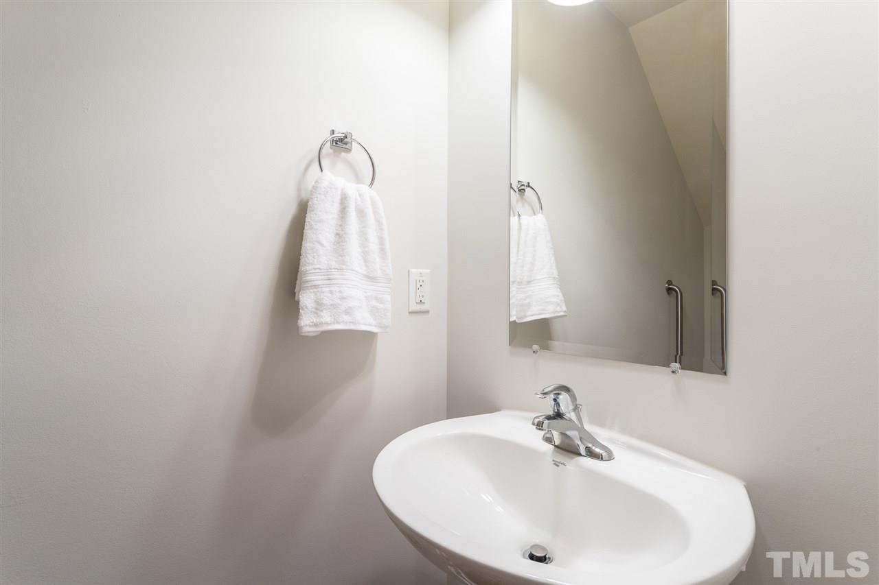 3106 Berkeley Springs Place Raleigh, NC 27616 - Photo 15 of 26 a bathroom with a sink and a mirror