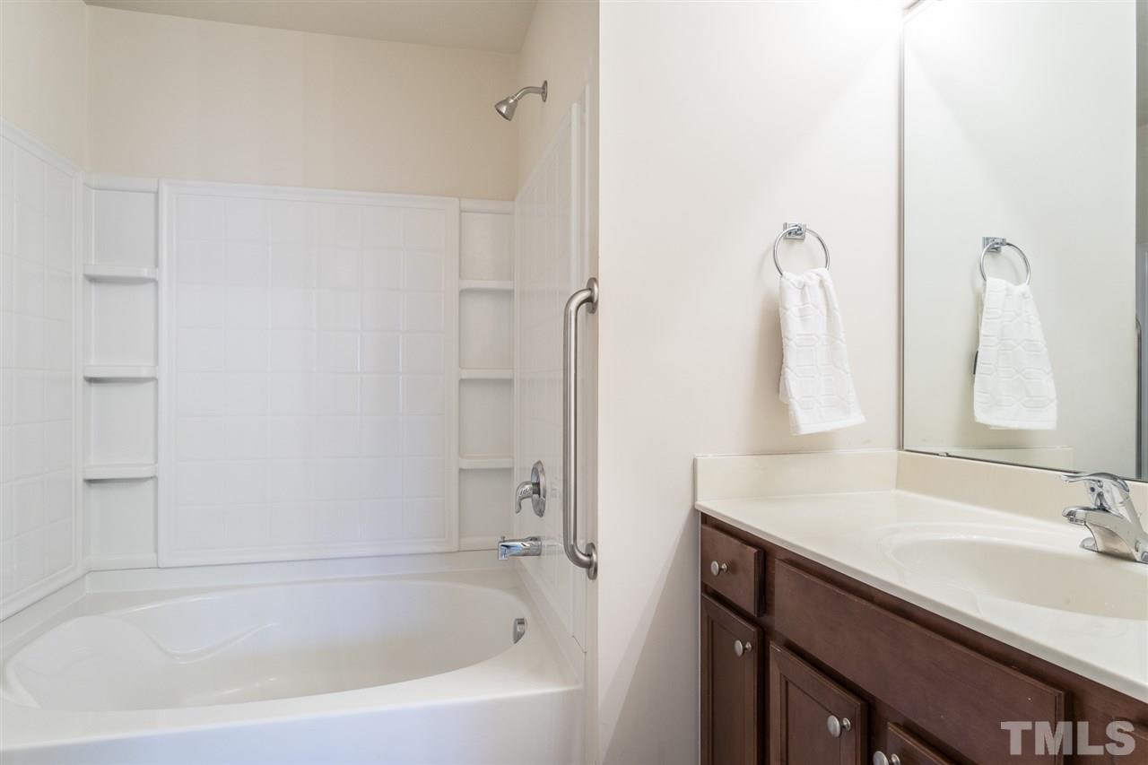 3106 Berkeley Springs Place Raleigh, NC 27616 - Photo 19 of 26 a white bath tub sitting next to a bathroom sink