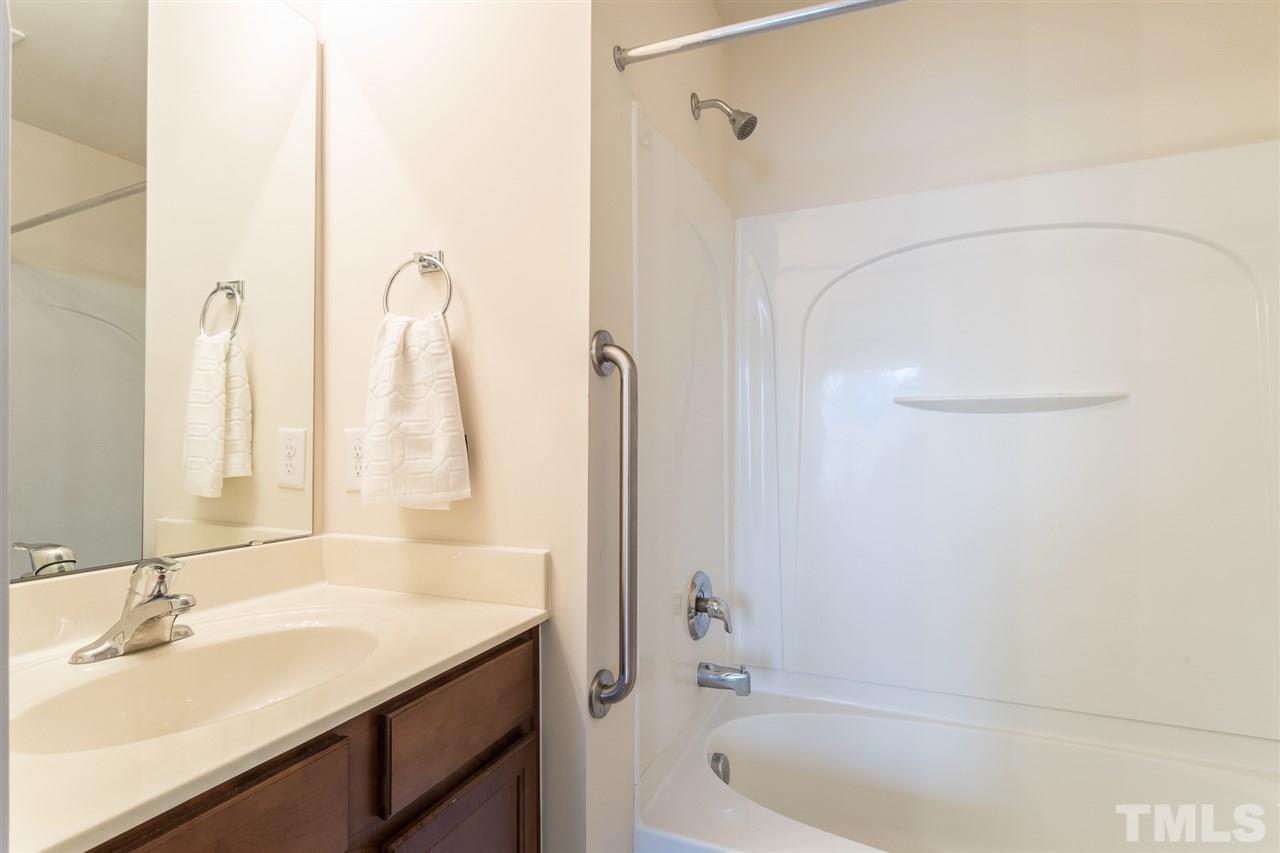 3106 Berkeley Springs Place Raleigh, NC 27616 - Photo 22 of 26 a bathroom with a granite countertop sink and a mirror