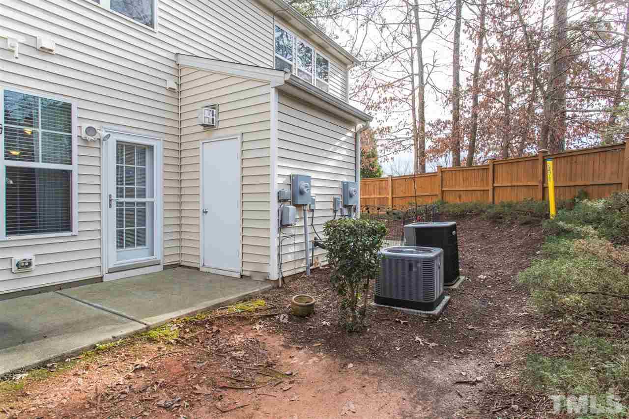 3106 Berkeley Springs Place Raleigh, NC 27616 - Photo 26 of 26 a backyard of a house with a large tree and plants