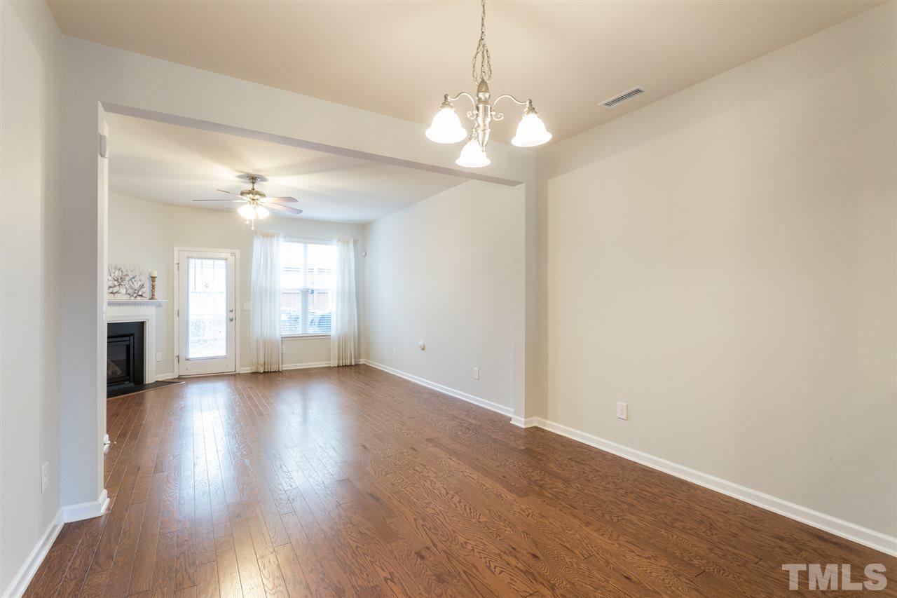 3106 Berkeley Springs Place Raleigh, NC 27616 - Photo 9 of 26 an empty room with wooden floor and windows