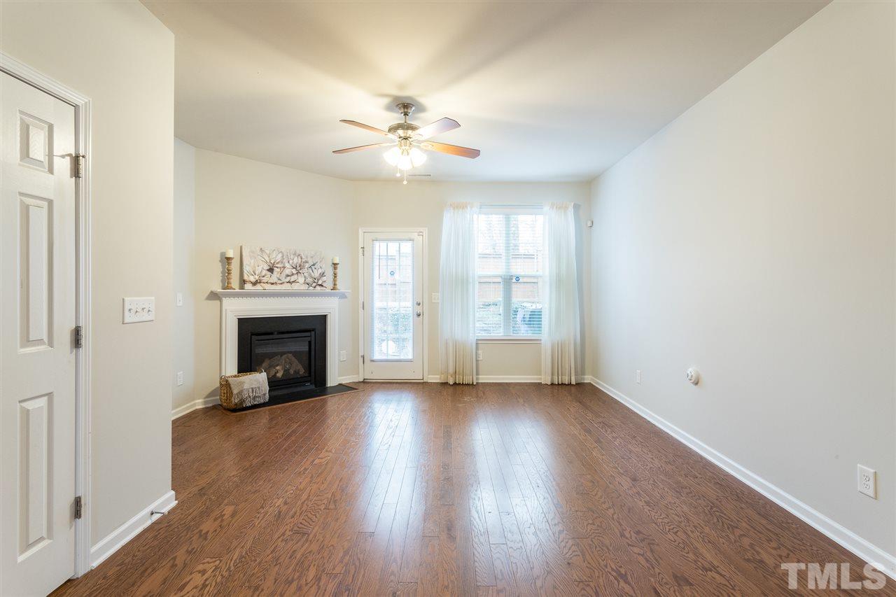 3106 Berkeley Springs Place Raleigh, NC 27616 - Photo 10 of 26 an empty room with wooden floor fan and windows