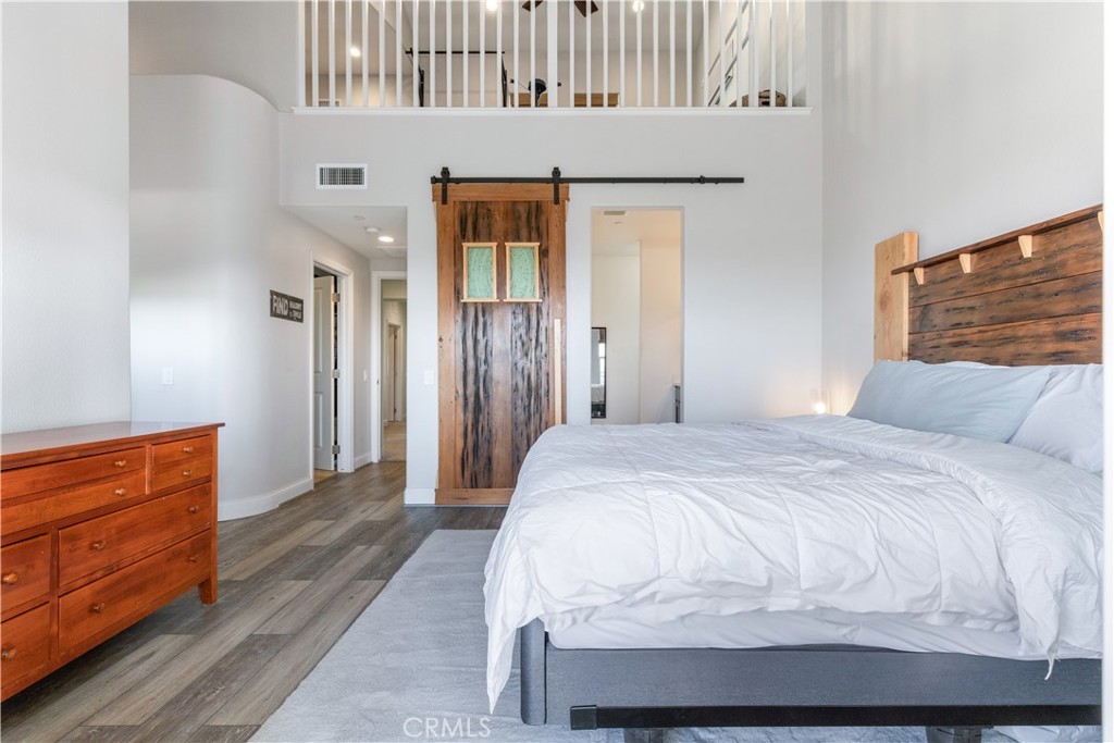 9354 Riberena Circle Atascadero, CA 93422 - Photo 33 of 47 a bedroom with a bed and wooden floor