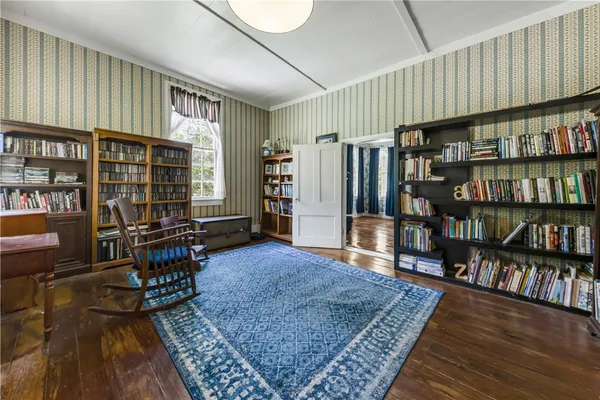 a living room with lots of furniture and a book shelf