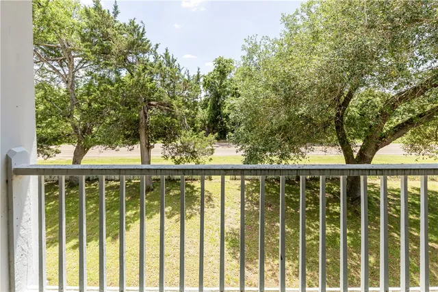 an aerial view of residential house with outdoor space and trees all around