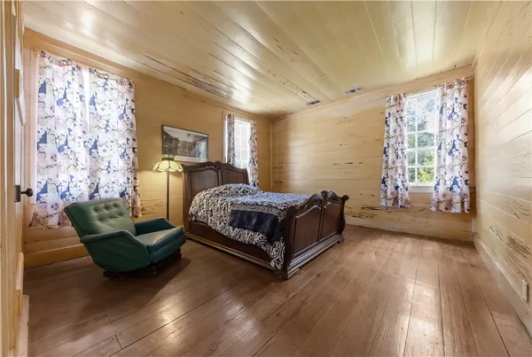 a spacious bedroom with a bed and a fireplace