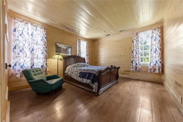 an aerial view of residential house with outdoor space and trees all around