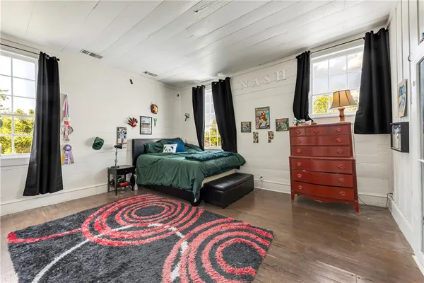an aerial view of residential house with outdoor space and trees all around