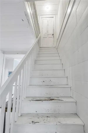an aerial view of residential house with outdoor space and trees all around