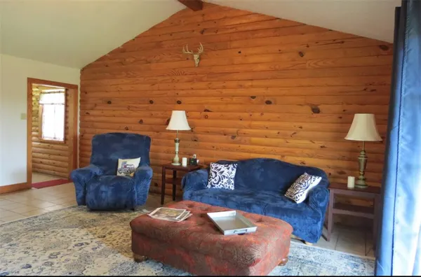 a view of a backyard of a house with a table and chairs