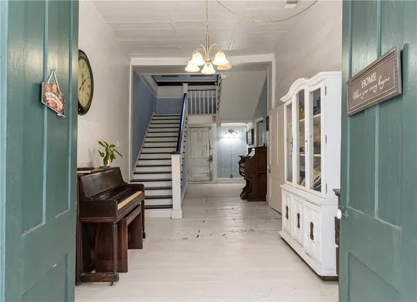 a view of living room kitchen and entryway