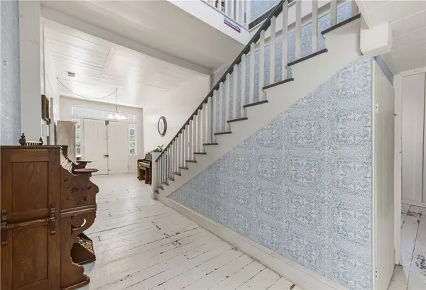 a view of entryway and hall with wooden floor