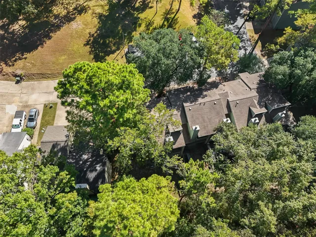 an aerial view of a house with a yard and lake view