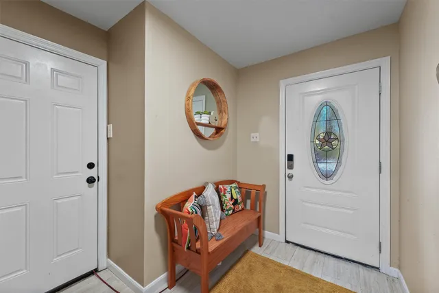 a view of an entryway with wooden floor