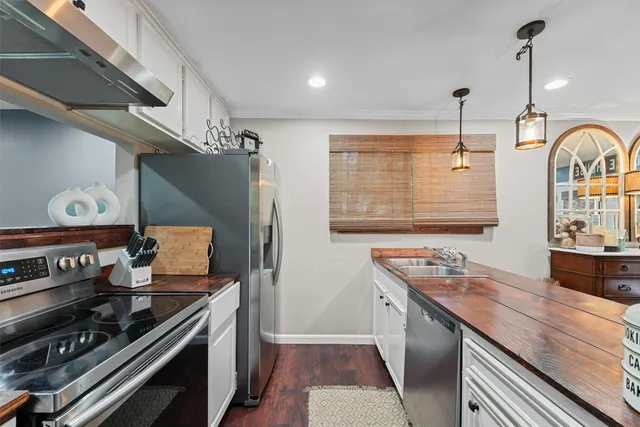a kitchen with stainless steel appliances granite countertop a stove and a sink
