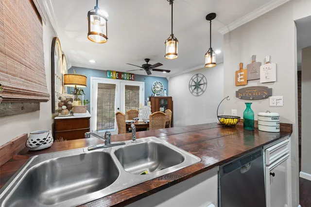 a kitchen with a sink a counter and chairs