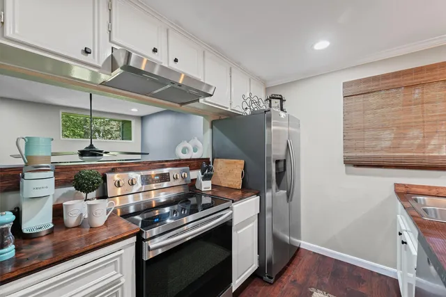 a kitchen with stainless steel appliances granite countertop a stove and a refrigerator