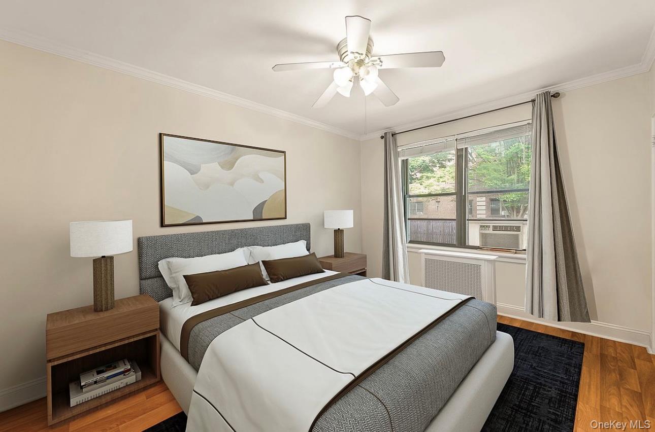 22-28 77th Street, Unit C1 Queens, NY 11370 - Photo 5 of 7 a bedroom with a large bed and a window