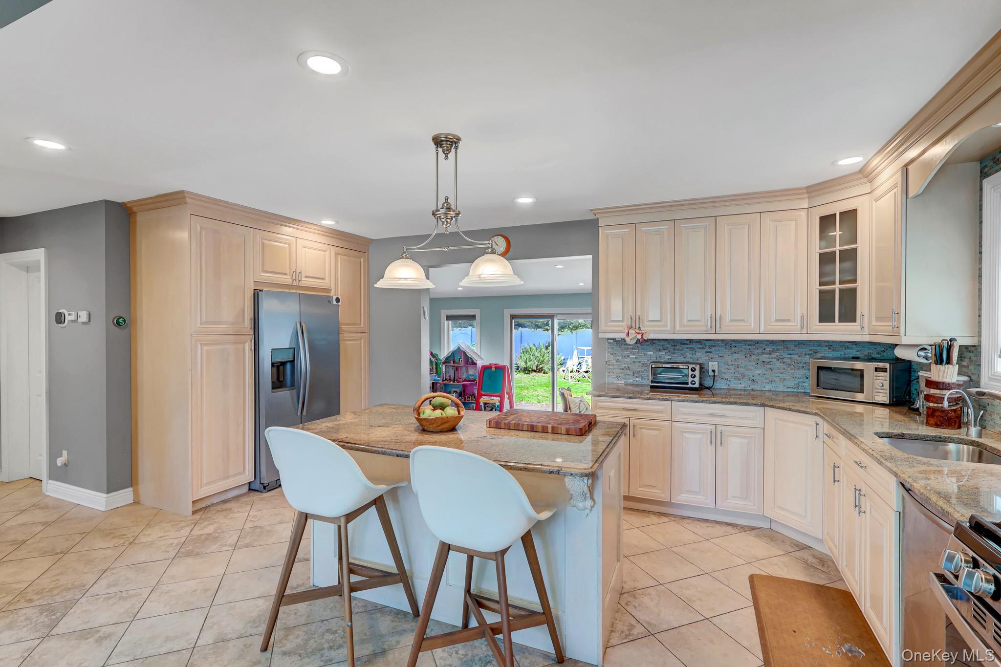 360 Westminster Road Cedarhurst, NY 11516 - Photo 9 of 31 LARGE EAT IN KITCHEN WITH GRANITE COUNTERTOPS AND CUSTOM CABINETS
