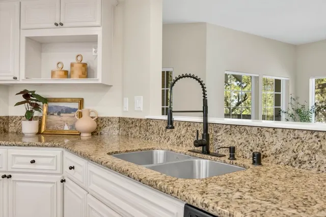 a kitchen with stainless steel appliances granite countertop a stove and a cabinets