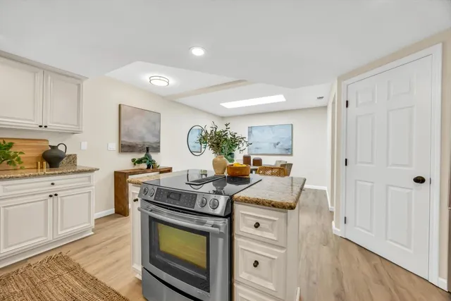 a kitchen with stainless steel appliances kitchen island granite countertop a sink and cabinets