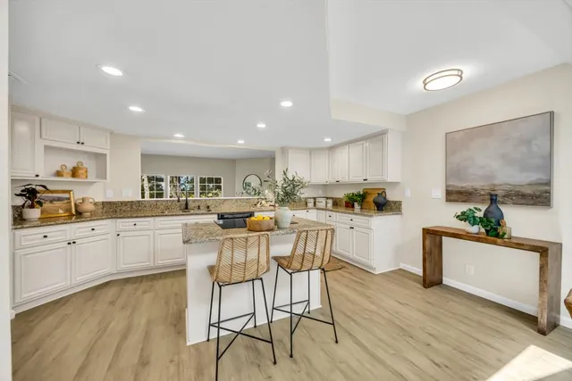 a dining room with furniture and potted plant