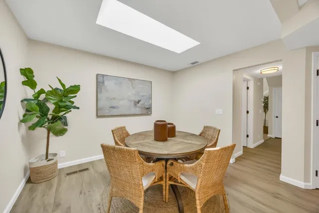 a dining room with kitchen island a table and chairs