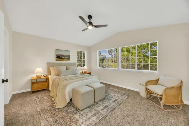 a bedroom with a large bed and wooden floor