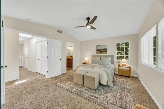 a bedroom with a bed and a large window