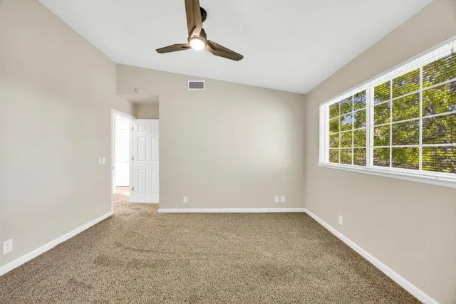 a bathroom with a granite countertop sink a toilet and a shower