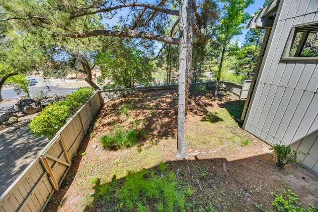 an aerial view of residential houses with outdoor space and street view