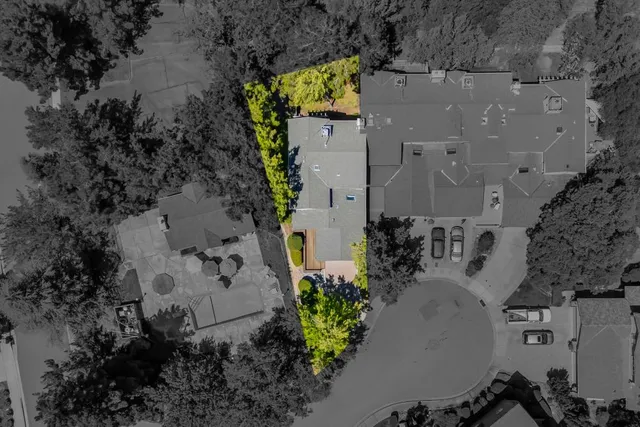 an aerial view of a house with a yard