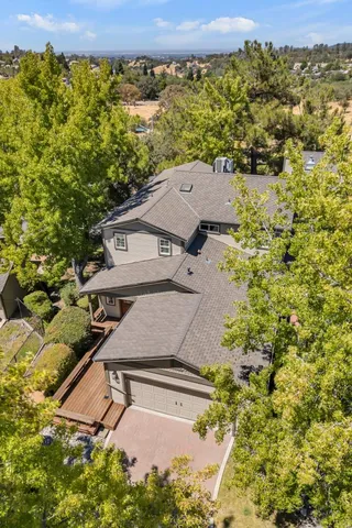 aerial view of a house with a yard and balcony