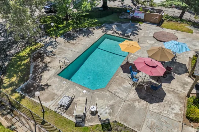 an aerial view of residential house with yard and swimming pool