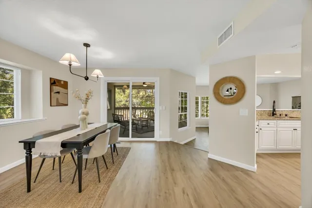 a view of a kitchen with a table and chairs