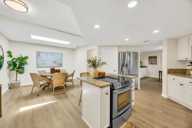a view of a dining room with furniture and wooden floor