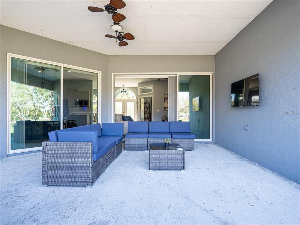10688 Southwest 129th Terrace Road Dunnellon, FL 34432 - Photo 35 of 35 a living room with furniture and a flat screen tv