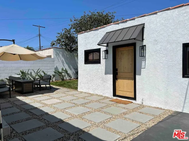 a view of a house with backyard and sitting area