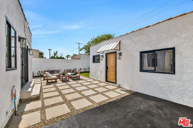 a view of a terrace with a dining table and chairs with wooden floor