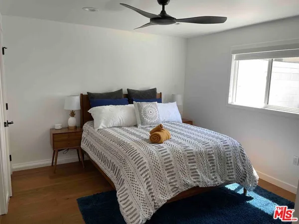 a bedroom with a bed and window